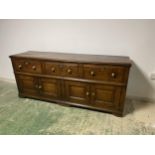 A good heavy oak side board, with 3 drawers, above 2 cupboard doors opening to reveal a curved