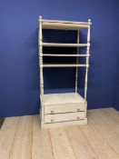 A grey painted shelving unit with 2 drawers to base, with decorative runed columns and finials