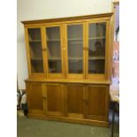 Large House keepers cupboard/bookcase, the glazed top with two pairs of doors, above the base of