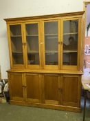 Large House keepers cupboard/bookcase, the glazed top with two pairs of doors, above the base of