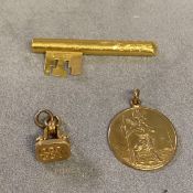 9ct gold St Christopher pendent, 6.1g; unmarked yellow metal key, and an unmarked yellow metal watch