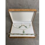 Chinese style, possibly jade jewellery suite consisting of drop earrings, panelled bracelet and