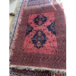 Persian rectangular rug , in muted reds and blue grounds with stylized geometric design 132 x 188cm