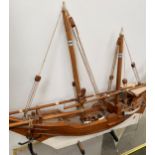 Cased model of a masked boat & another uncased, & pair of bellows. Condition: both with much wear