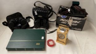 Quantity of stamps in album, camera, binoculars, carriage clock etc, all as found