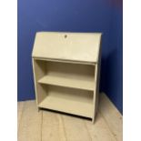 A cream painted narrow bureau, the fall flap opening to reveal fitted interior, above two shelves