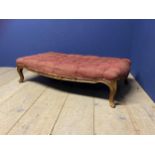 Red upholstered show framed stool, with cabriole legs, much wear. 118cm x 67cm x 31 cm