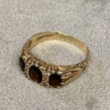 9ct gold garnet and diamond ring, three oval cut garnets with diamond separators, 3.5g, size R