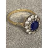 18ct gold sapphire and diamond flower ring, central 8 x 6 central sapphire with a surround of 14 old