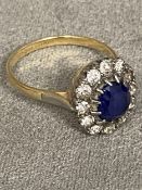 18ct gold sapphire and diamond flower ring, central 8 x 6 central sapphire with a surround of 14 old