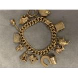 9ct gold curb link charm bracelt, set with numerous 9 ct and yellow metal charms 48.7g