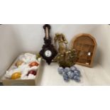 Quantity of decorative blue and white balls, a wooden and glass display case, 2 abstract bronze