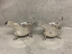 Pair Hallmarked Silver sauceboats with leaf capped scroll handles on cast shell feet by Mappin &