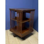 A revolving walnut 3 tier bookcase