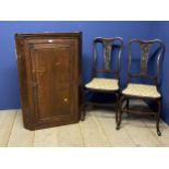 Oak corner cabinet, and a pair of dining chairs