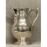 Hallmarked Silver wine jug, the baluster body with a scroll spout & handle 22cm by Richard Conyns