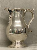 Hallmarked Silver wine jug, the baluster body with a scroll spout & handle 22cm by Richard Conyns