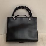 Ladies black leather Gucci handbag and dust cover, with some wear to the bamboo style handles