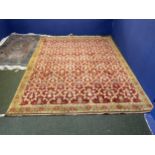 A good Persian rug with soft burgundy ground with all over geometric pattern, within a soft green