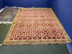 A good Persian rug with soft burgundy ground with all over geometric pattern, within a soft green