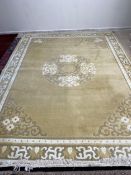 Belgian Carpet plain oatmeal ground, with central four central panels and corners, within a multi