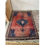 Persian burgundy ground Rug, with blue central lozenge and corner lozenges, and multi border 230cm x