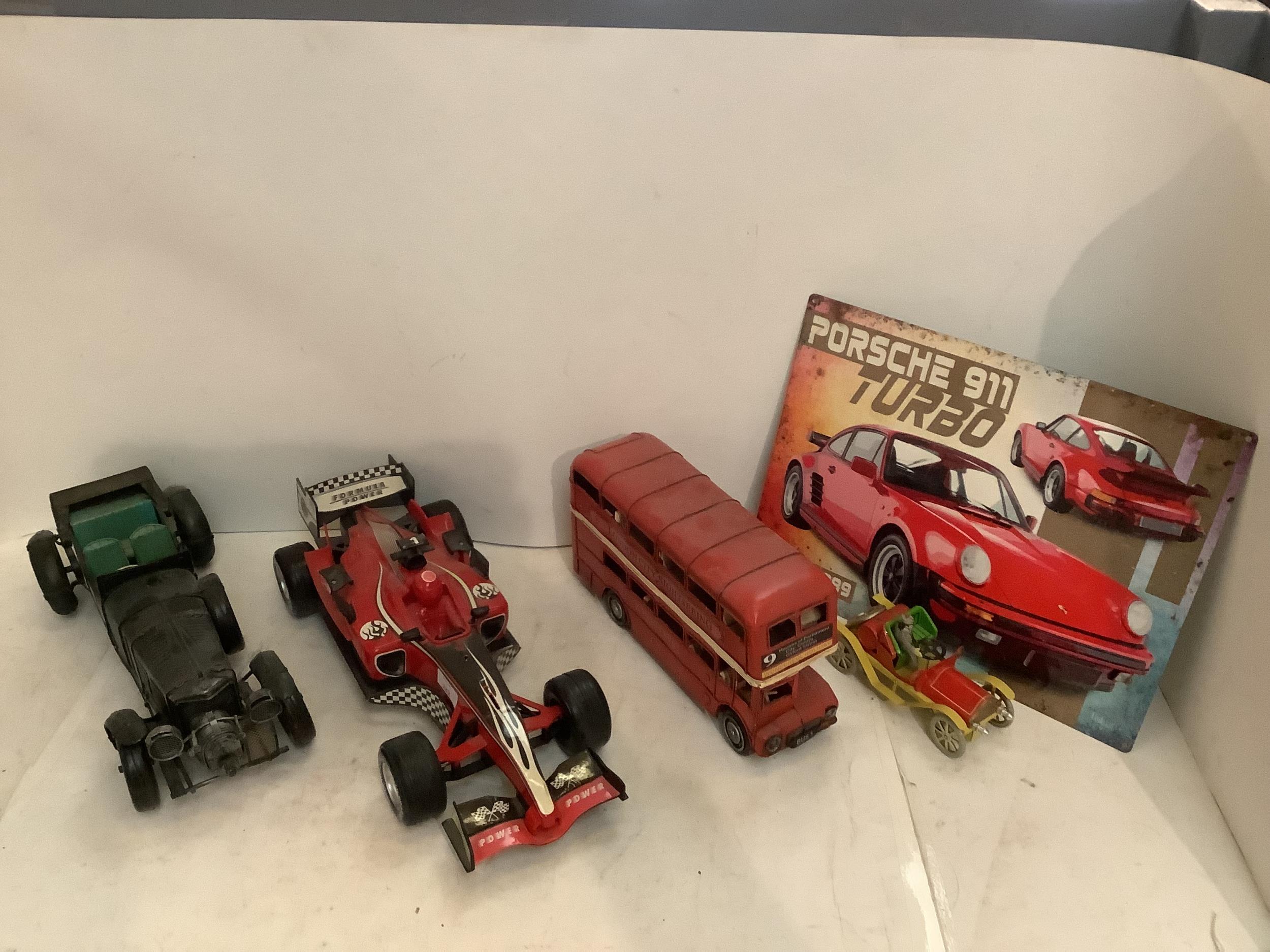 Quantity of toys to include a battery operated racing car, tin plate toys, Bus, Porche tin, poster