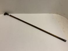 A Malacca walking cane, the associated handle as a brass bulldogs head with glass eye