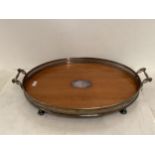 A large oval galleried 2 handled Edwardian tray, on 4 silver plate bun feet