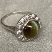 An Art Deco Chrysoberyl Cats Eye, and diamond ring, unmarked white metal, (platinum), ventral