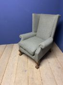 A good herringbone tweed upholstered winged arm chair, with loose cushion, on ball and claw feet, in