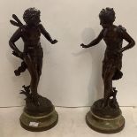 A pair of elegant bronze figures, a winged archer, and a lady, mounted on a onyx pedestal base,