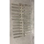 A set of 12 Hallmarked silver fish knives and forks in a material roll; fork approx 59g, knife