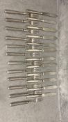 A set of 12 Hallmarked silver fish knives and forks in a material roll; fork approx 59g, knife