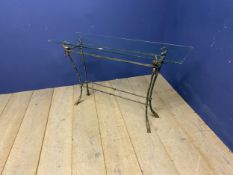 A good decorative, glass topped, narrow console table, with decorative iron work and brass base,