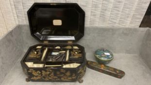 A black chinoiserie style antique work box, open to reveal fitted interior, and trays and drawers,