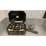 A black chinoiserie style antique work box, open to reveal fitted interior, and trays and drawers,