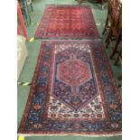 Two rugs: Traditional Persian Rug with central terracotta lozenge, within a blue panel surrounded by