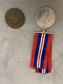 A WWII 1939-45 medal together with an antique worn copper coin, A red cased set of knife, fork