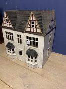 A painted dolls house, with furniture and accessories, repair to inside of right hand door - see