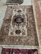 Persian Rug with central oatmeal ground panel, and soft terracotta border and central lozenge,