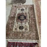 Persian Rug with central oatmeal ground panel, and soft terracotta border and central lozenge,