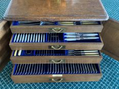 A good heavy oak cased four drawer canteen of cutlery , with brass handles , inset label to one