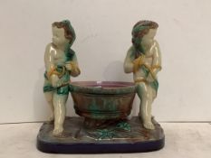 Majolica style bowl on stand, flanked by a pair of cherubs, damaged and a rose quartz plate stand