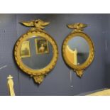 A pair of large handsome circular bevelled gilded wall mirrors, captain style, with ball decorations