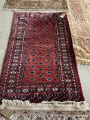 Persian, red ground Rug with multi diamond lozenge within wide multi pattern border 152cm x 94cm