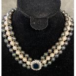 Triple strand of graduated Tahitian pearls of purple, green and white hues, largest pearl is 10mm