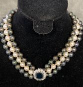 Triple strand of graduated Tahitian pearls of purple, green and white hues, largest pearl is 10mm