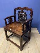 A good Chinese heavy hardwood arm chair with solid seat and carved back and arm panels, with a