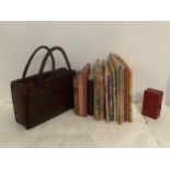 A quantity of children's vintage books, including "pop up" book, a vintage handbag and a Cartier